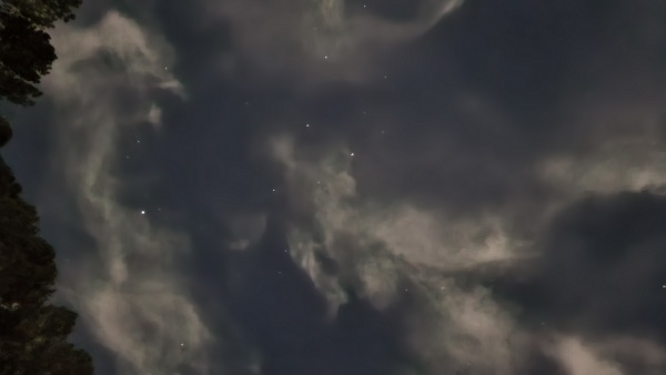 Moonlight on thin clouds and stars make a abstract pattern